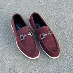 maroon loafers with silver buckles