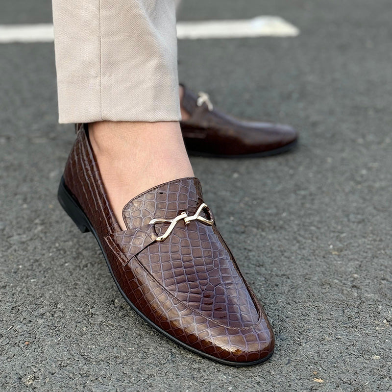 A man's foot wearing a brown premium leather handmade shoe
